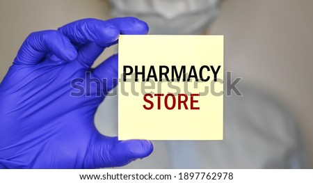A man wearing gloves and a mask hold sticker with space for text. Medical concept. Template