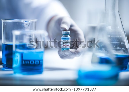fight against COVID-19, coronavirus vaccine research in hospital laboratory, professional scientists holds bottle of new vaccine for virus cure treatment injection, medicine clinical during pandemic