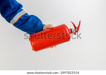 fireman man holding a fire extinguisher, safe work and precautions concept