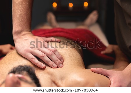 Sports massage. Breast massage. Physiotherapist doing a male breast massage to an athlete to a patient. Close-up
