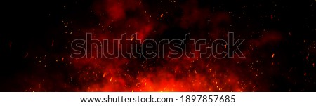 Fire embers particles over black background. Fire sparks background. Abstract dark glitter fire particles lights. Royalty-Free Stock Photo #1897857685