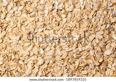 Heap of dry rolled oats isolated  Royalty-Free Stock Photo #1897859335