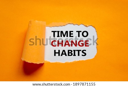 Time to change habits symbol. The text 'Time to change habits' appearing behind torn orange paper. Business, growth and time to change habits concept. Copy space. Royalty-Free Stock Photo #1897871155