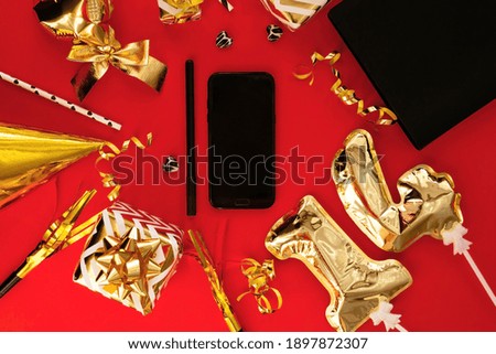 14 February. Lots of gifts, smartphone for Valentine's Day isolated on red background. Holidays concept. The view from the top.