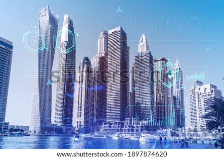 Skyscrapers of Dubai business downtown. International hub of trading and financial services. Technology theme icons hologram, Fintech concept. Double exposure. Dubai Canal waterfront.
