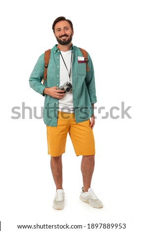 Cheerful traveler with photo camera