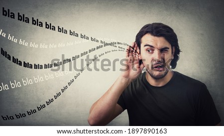 Curious and gossipy man, hand to ear gesture, trying to listen distant nonsense conversations, empty bla blah words. Slanderer guy want to hear foreign secrets, makes big eyes looks aside astonished Royalty-Free Stock Photo #1897890163