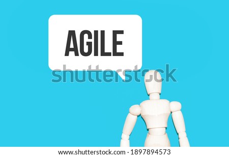 The wooden man and white cloud with text AGILE. The content of the lettering has implications for business concept and marketing.