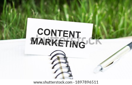 Text content marketing on the background of an open notebook and pen