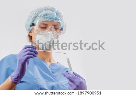 A laboratory employee taking sample PCR microtubes with cotton swab test. Diagnostic testing for COVID-19. The concept of the diagnosis of viral diseases. Selective focus. Isolated on white. Royalty-Free Stock Photo #1897900951