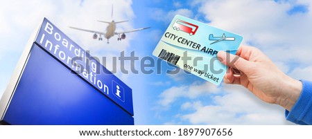 Female hand holds Bus tickets from city center to airport and return agains a signage for boarding information at terminal airport - concept image - The contents of the image are totally invented.