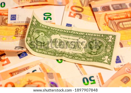Fifty euro money banknotes background texture and one usd american dollar in close up
