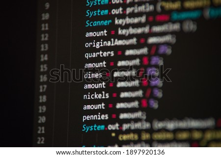 Software developer programming code. Abstract computer script code closeup on monitor screen with bokeh.