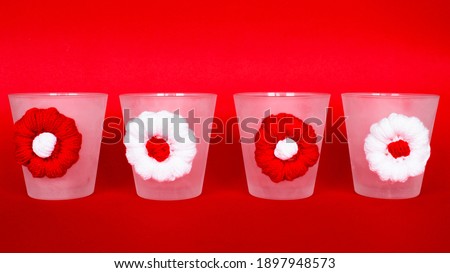 Handmade candle Holders isolated on red background. A group of glass candle holders for valentines day concept. Valentines day gifts