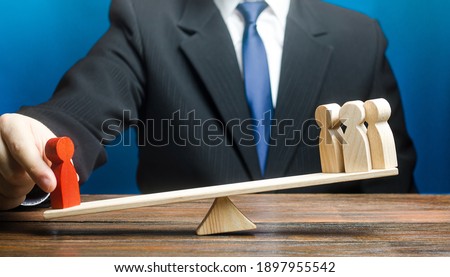 Man opposes red man to group of people on scales. Give a head start. Get an edge advantage. Career growth, nepotism. Leader and valued employee. Inequality of rights. Social significance. Royalty-Free Stock Photo #1897955542
