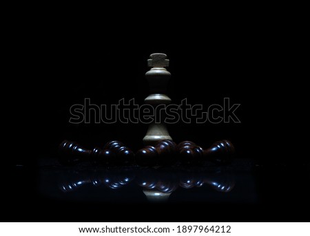 Wooden chess pieces in black background