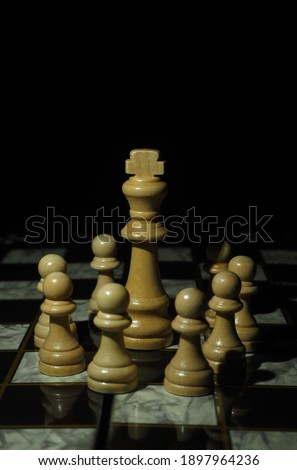 Wooden chess pieces in black background