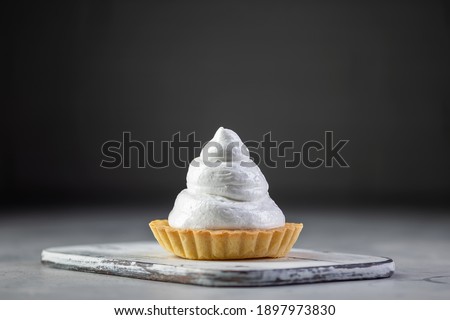 Homemade lemon meringue pie baked on black background
