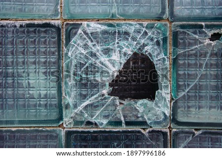 Old broken glass block window, close up view.