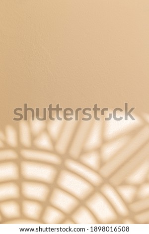 Abstract geometric shadows on yellow natural material wall. Sunny warm background Royalty-Free Stock Photo #1898016508