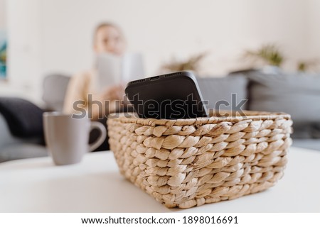 Millennial girl at home refuse using phone and reading a book. Social media addiction. Waste of time. Unplugged. Dependance concept Royalty-Free Stock Photo #1898016691