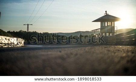 An old watchtower on a out of order rallycross track, pictured in sunrise.