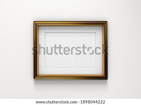 Golden picture frame on a white wall. Ideal for mock-ups