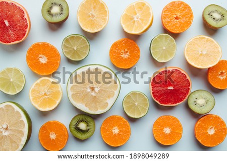 Summer vibes. Tropical background, citrus texture on blue background. Summertime vacation, cocktail, tropical beach. Creative fruity layout