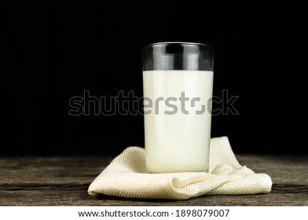 Almond milk on sack with a wooden table on dark background. Healthy food. Food and drink concept. Diet, Health.