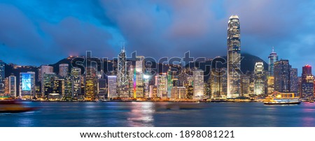 Hong Kong, China downtown cityscape from the harbor at dusk.