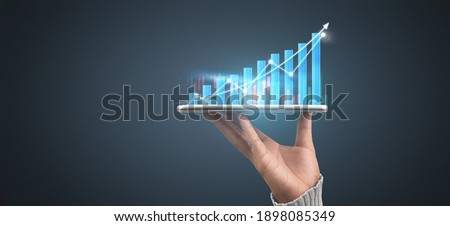 Businessman plan graph growth and increase of chart positive indicators in his business,tablet in hand Royalty-Free Stock Photo #1898085349