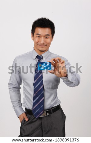 A young business man with a bank card high quality photo