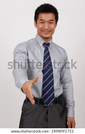 A young business man gesturing in a shirt high quality photo