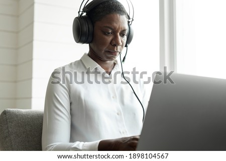 Female call centre operator using a laptop