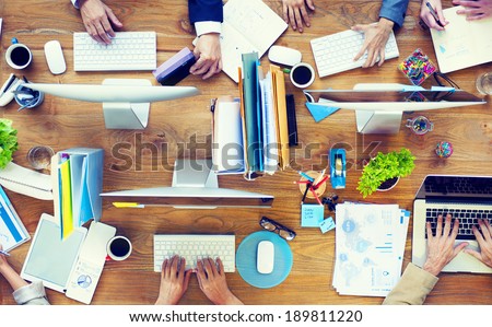 Group of Business People Working on an Office Desk Royalty-Free Stock Photo #189811220