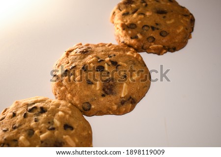 a piece of almond chocolate cookie on white background