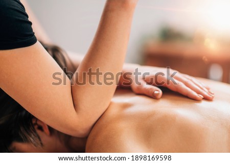 Lomi Lomi Hawaiian back massage, elbow press Royalty-Free Stock Photo #1898169598
