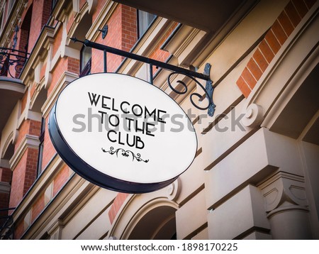 Welcome to The Club signage hanging banner. Business owner puts an open sign.