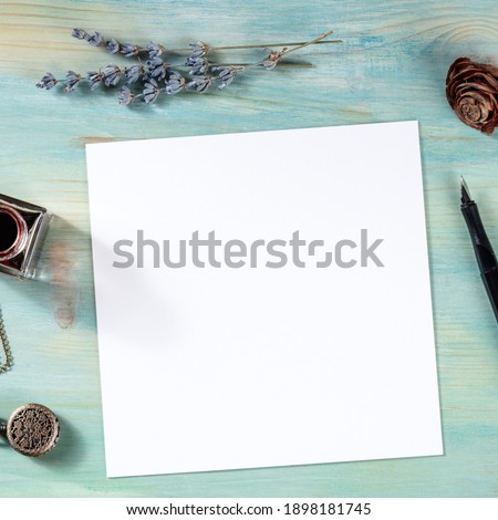 Square greeting card or invitation design template, shot from above with a place for text and lavender