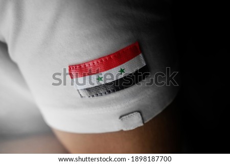 Patch of the national flag of the Syria on a white t-shirt