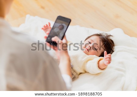 Mother taking a picture of a baby