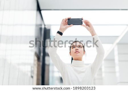 Girl taking a photo with her smartphone