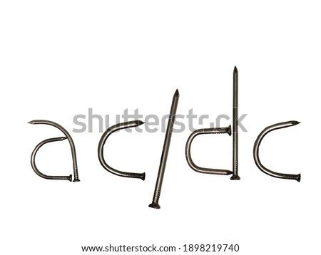         The inscription "ac dc" lined with iron nails on a white background.                     