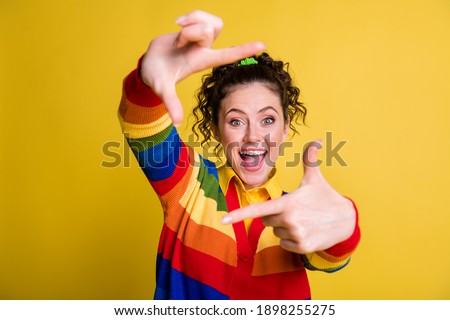 Portrait of funky lady make hands photo focus measure fingers frame wear striped sweater isolated yellow color background
