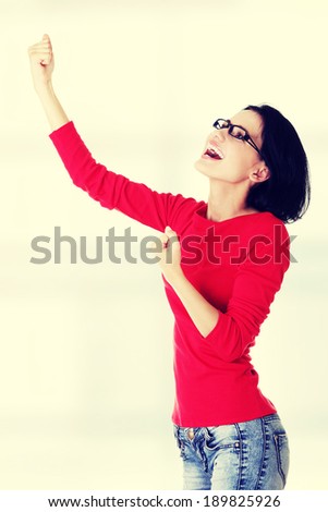 Excited happy young woman with fists up