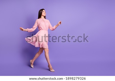 Full body profile photo of cheerful person walking wear retro stilettos isolated on purple color background Royalty-Free Stock Photo #1898279326