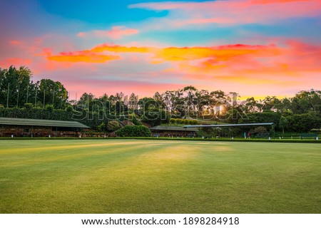 sunset over Bowls field with colourful clouds and sun rays