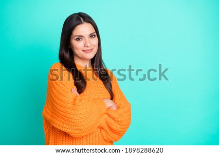Photo of charming mature woman crossed arms look camera wear orange sweater isolated turquoise color background