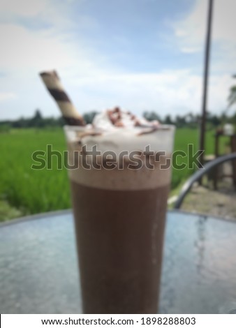 blurry of a glass chocolate milkshake