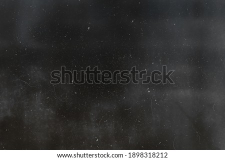 Abstract dirty or aging film. Dust particle and grain texture or dirt use for overlay film frame effect with space for vintage grunge design. Royalty-Free Stock Photo #1898318212